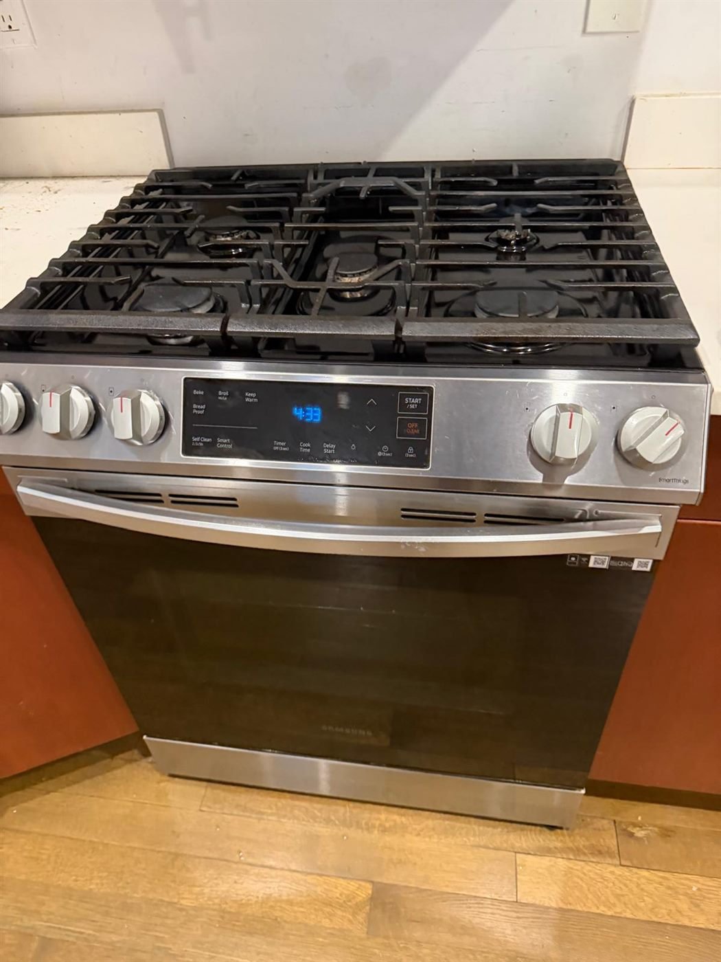 Spotless stainless steel gas range after a move-out deep cleaning in Greater Boston