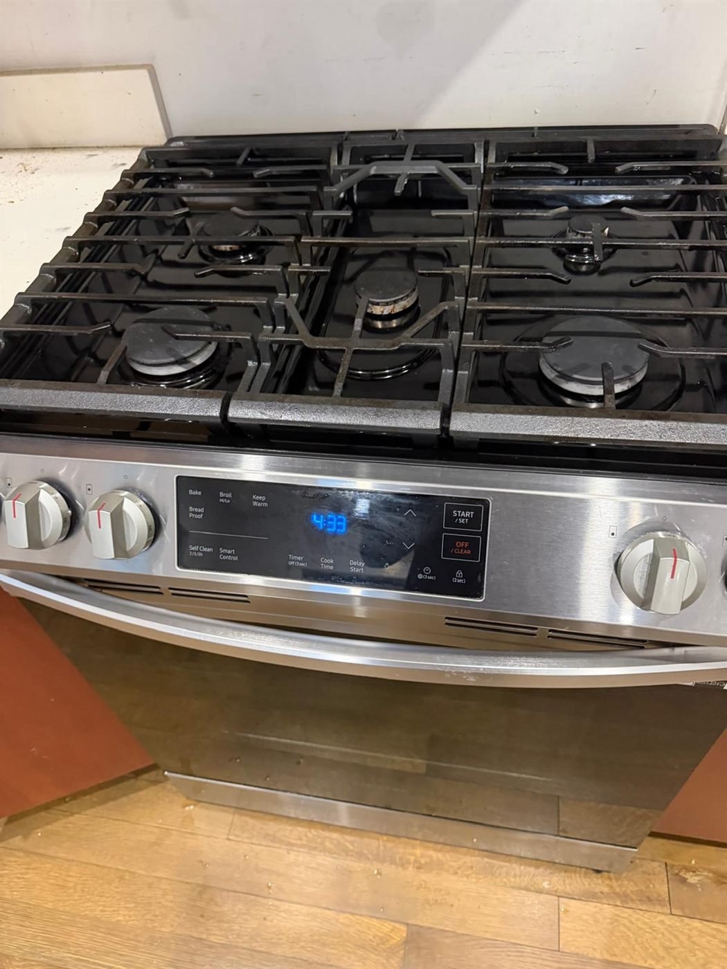 Spotless stainless steel gas range after a move-out kitchen cleaning