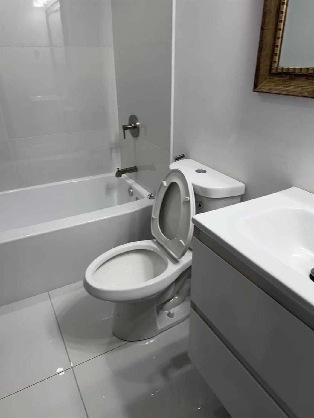 Freshly cleaned bathroom with sink, toilet, and mirror ready for the next tenant