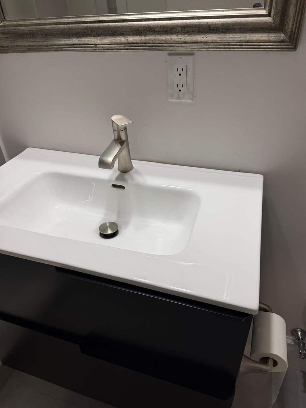 Modern black vanity with a polished sink after a turnover cleaning